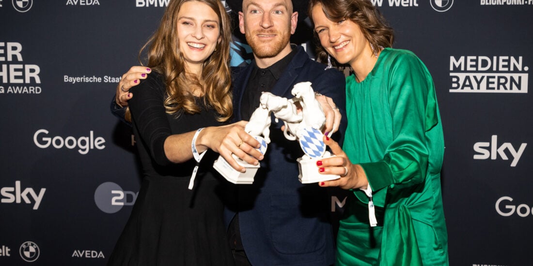 Annette Kammerer, Jann Volmer und Nadja Mitzkat (v.l.n.r.) vor der Pressewand bei der Preisverleihung 2022